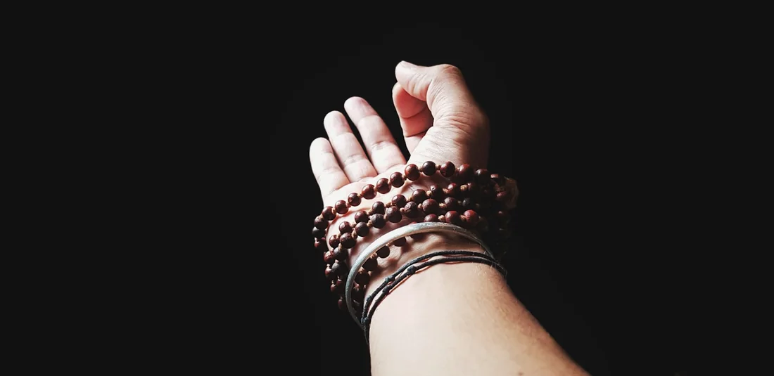 Hand in Gyan Mudra with mala beads